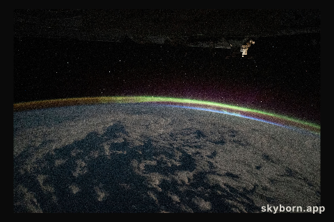 The aurora australis intersects Earth's atmospheric glow in this photograph from the International Space Station as it
