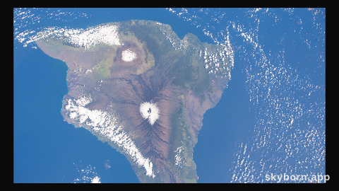 The snow-capped peaks of two different volcanoes on the island of Hawaii, Mauna Loa, an active volcano (bottom),