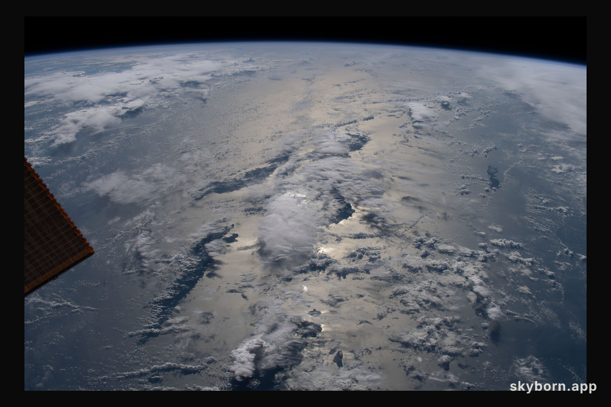 The sun's glint beams across the Solomon Sea revealing the cloud-covered Solomon Islands as the International Space
