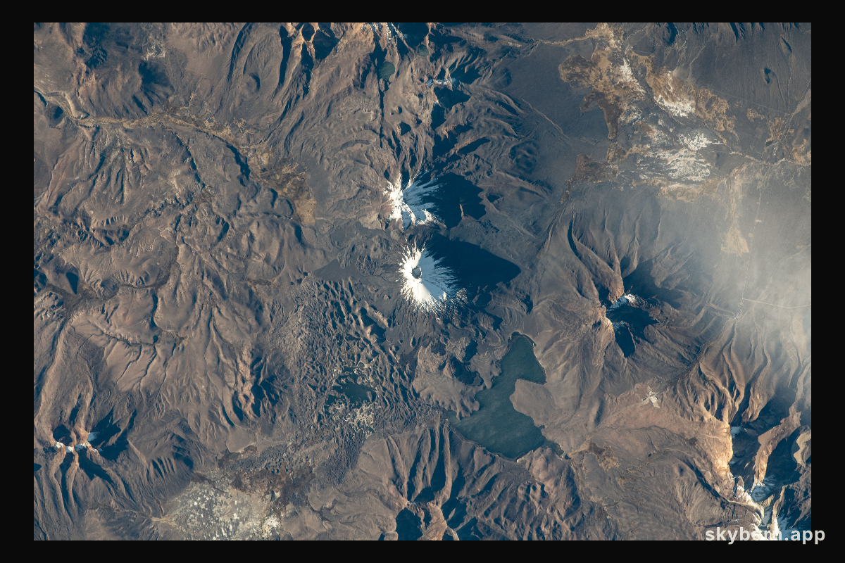 The Pomerape (center top) and Payachata (center bottom) volcanoes and Chungará Lake, on the border between the nations