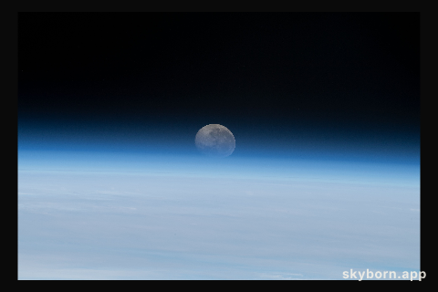 The Moon begins setting below Earth's horizon the atmosphere refracting, or bending, its light making it appear flatter