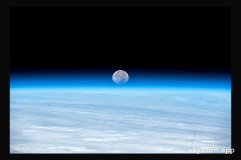 The Moon's image is refracted due to Earth's atmosphere in this photograph from the International Space Station as it