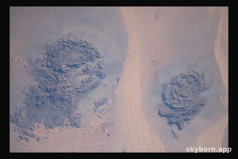 Located in the Libyan Desert along the country's southeastern border with Sudan and Egypt are the Jebel Uweinat (left)
