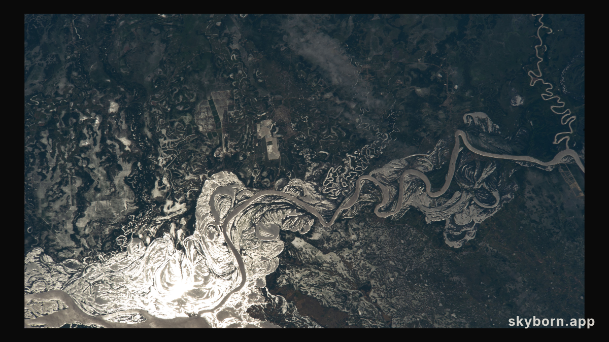 The sun's glint beams off the Paraguay River which separates a portion of the South American nations of Argentina