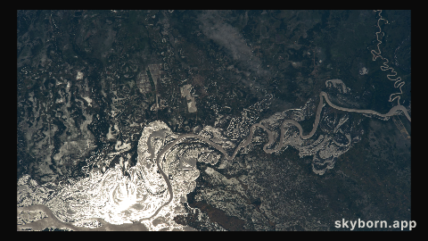 The sun's glint beams off the Paraguay River which separates a portion of the South American nations of Argentina