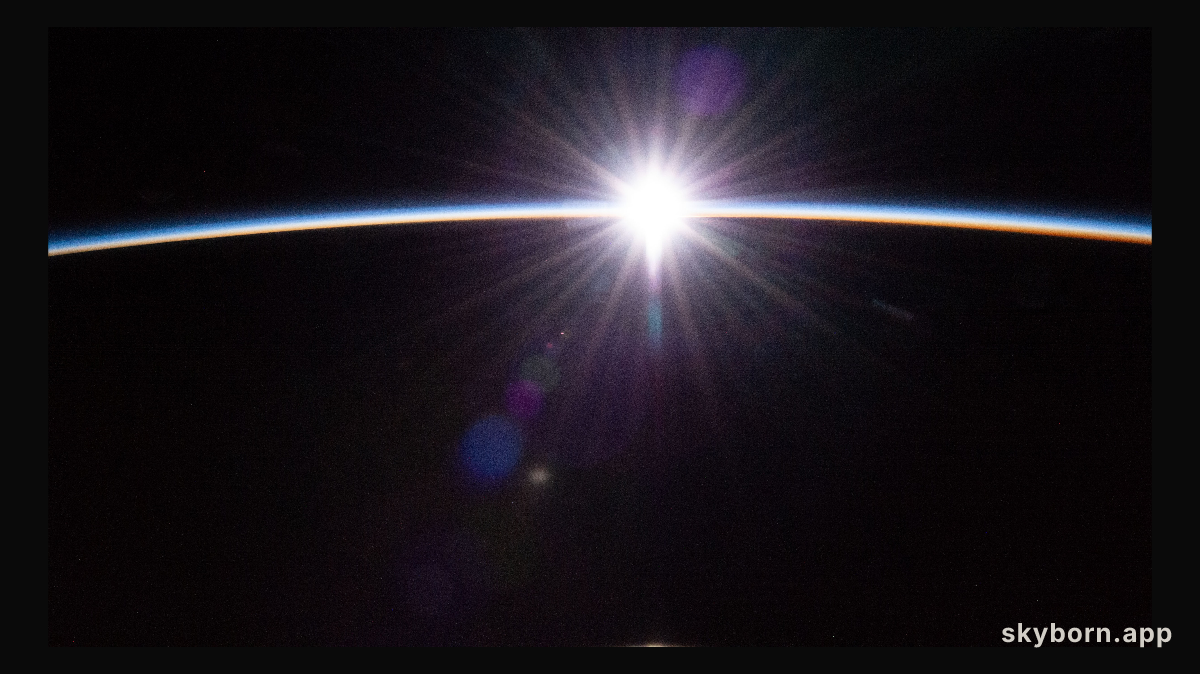 The sun's first rays burst through the Earth's atmosphere in this photograph from the International Space Station as it