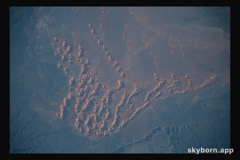 Sand dunes and massifs in the Algerian Desert are pictured from the International Space Station as it orbited 260 miles