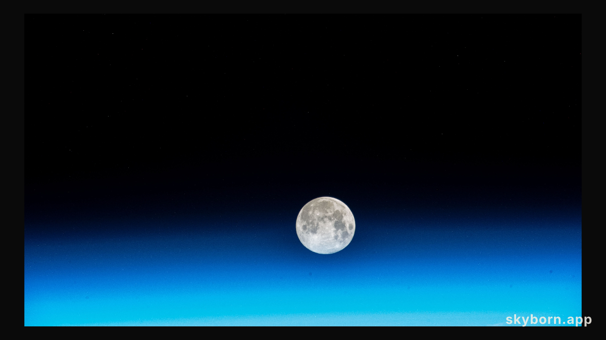 The near Full Moon is pictured just above Earth's atmosphere in this photograph from the International Space Station