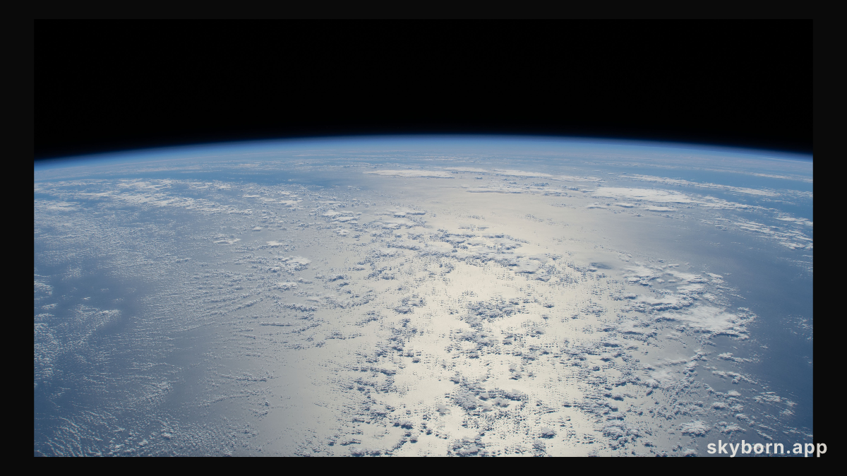 The sun's glint beams off a tranquil, blue Atlantic Ocean in this photograph from the International Space Station as it