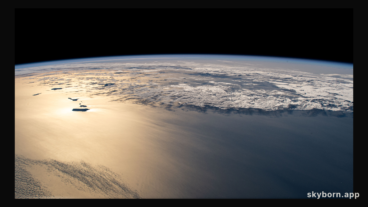 The sun's glint beams off the Atlantic Ocean revealing the island country of the Republic of Cabo Verde (left) off