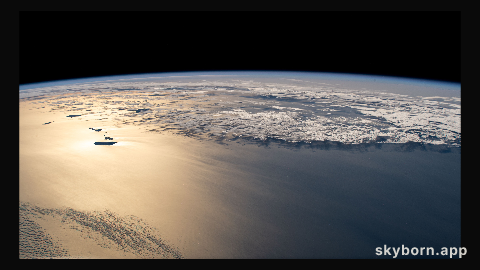 The sun's glint beams off the Atlantic Ocean revealing the island country of the Republic of Cabo Verde (left) off