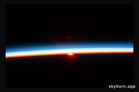 The sun's last rays illuminate Earth's atmosphere in this photograph of an orbital sunset from the International Space