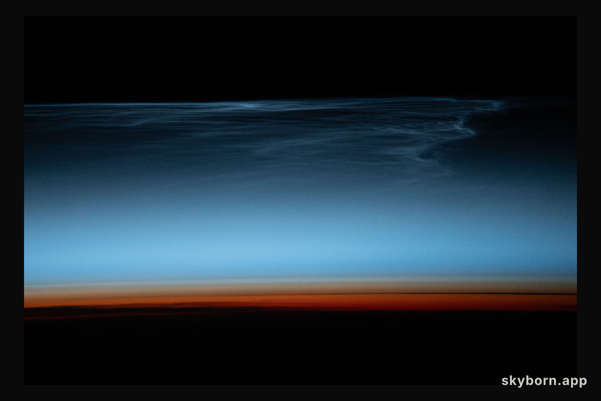Noctilucent clouds, wispy clouds in Earth's upper atmosphere illuminated by the sunlight just after sunset, are
