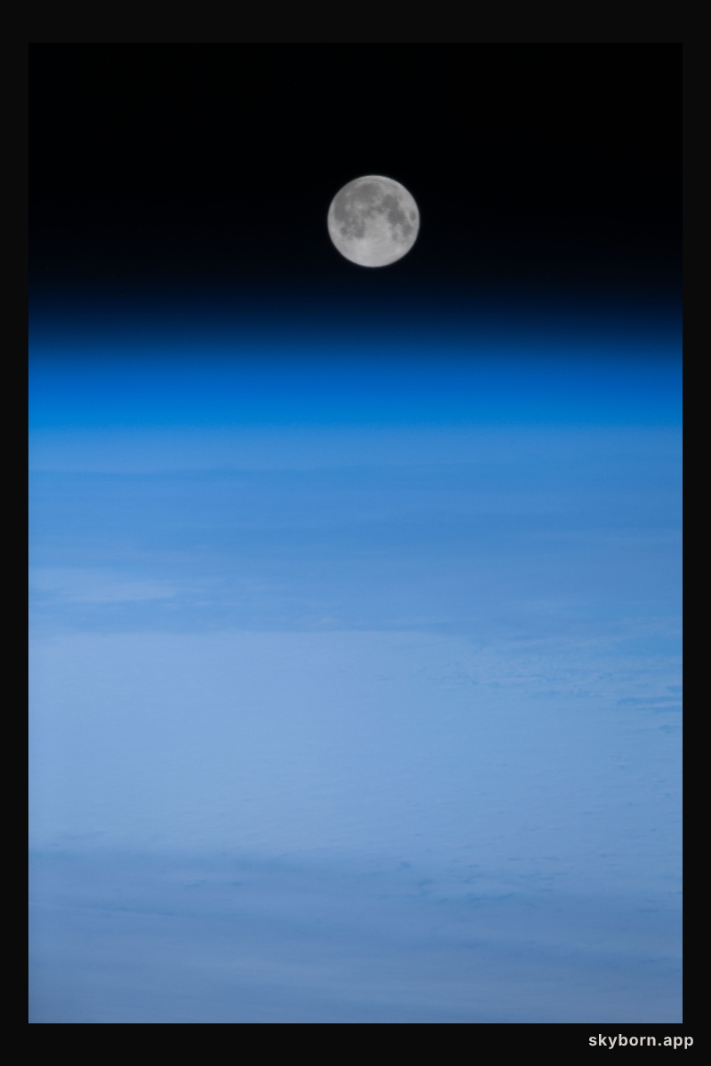 The Full Moon is pictured above Earth's horizon in this photograph from the International Space Station as it orbited