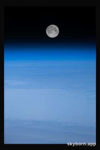 The Full Moon is pictured above Earth's horizon in this photograph from the International Space Station as it orbited