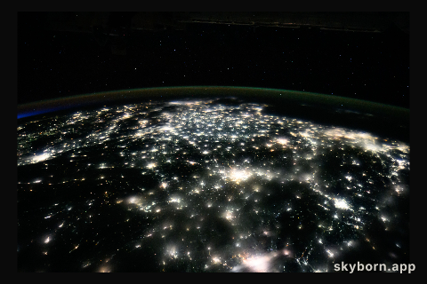 City lights illuminate the country of China to the East China Sea in this nighttime photograph from the International