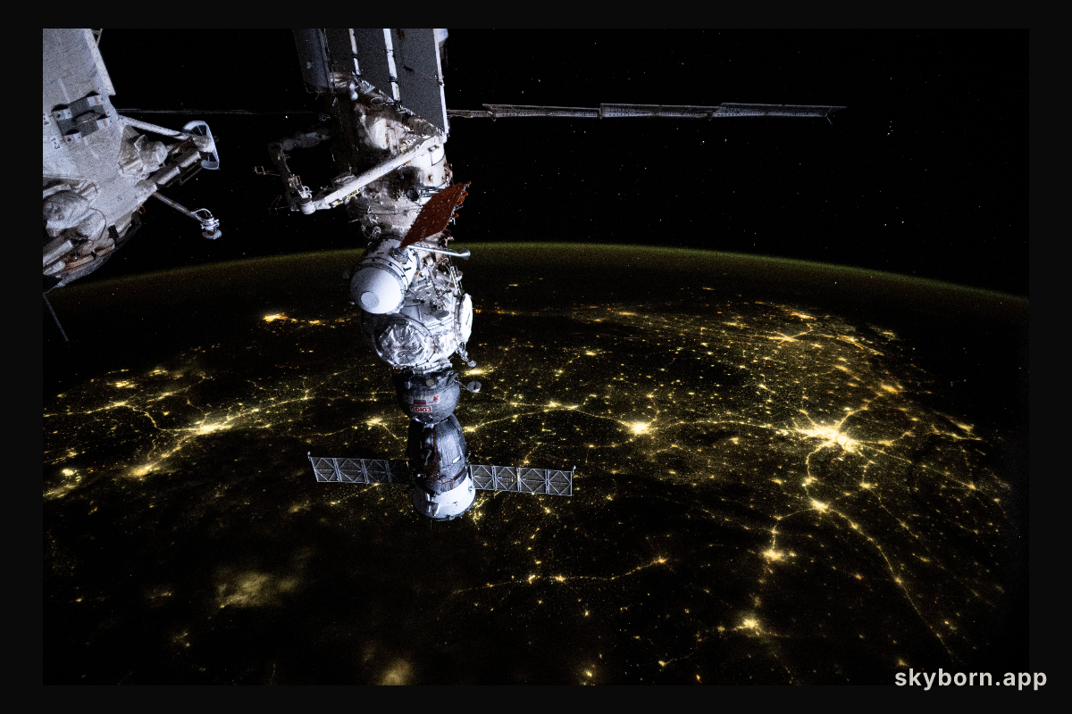 An atmosphreric glow blankets Earth's horizon and a web of city lights interconnect across India in this photograph