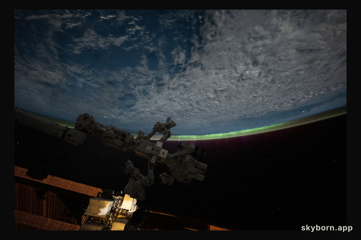 An aurora crowns Earth's horizon in this photograph from the International Space Station as it orbited 265 miles