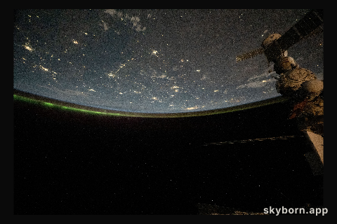 The city lights of central Asia and an aurora crowning Earth's horizon are pictured in this photograph