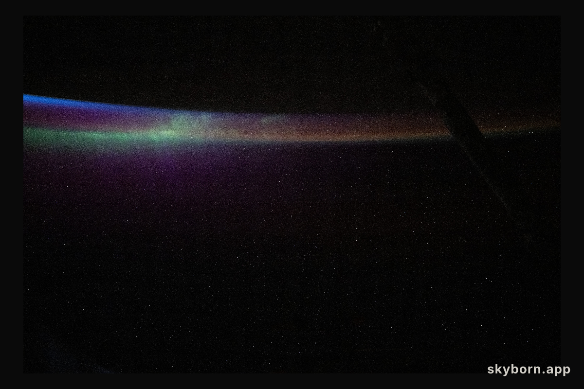 The aurora australis blends into Earth's atmospheric glow