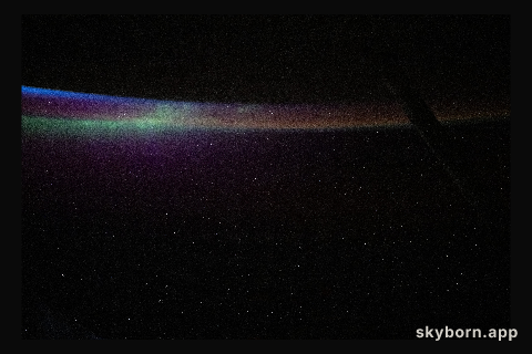 The aurora australis blends into Earth's atmospheric glow