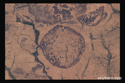Ancient settlements surround this circular, geological feature in Mali