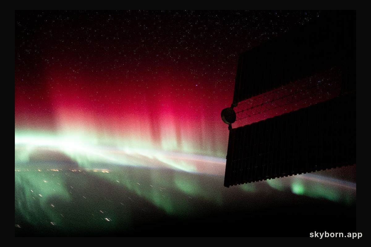 A red and green aurora shimmers brightly above Ontario, Canada