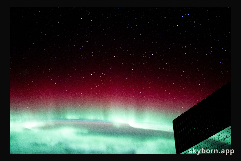 A red and green aurora borealis above Canada's Gulf of St. Lawrence