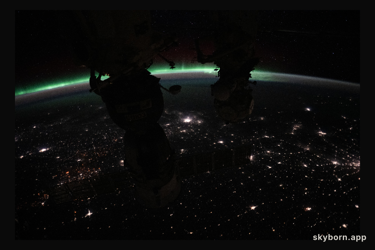 The aurora borealis crowns Earth's horizon above Canada