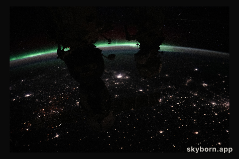 The aurora borealis crowns Earth's horizon above Canada