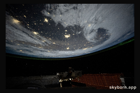 City lights dot the cloudy, midwestern landscape of the United States