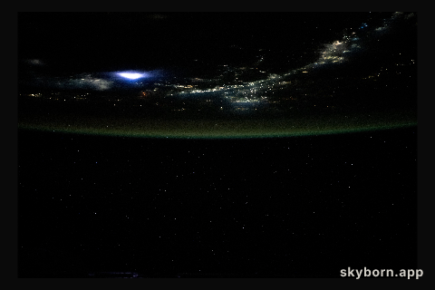 Lightning illuminates the clouds above Southeast Asia