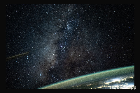 The Milky Way appears above Earth's bright atmospheric glow