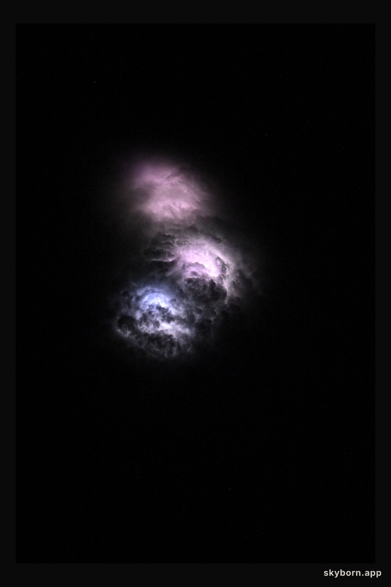Lightning strikes illuminate the stormy cloud tops