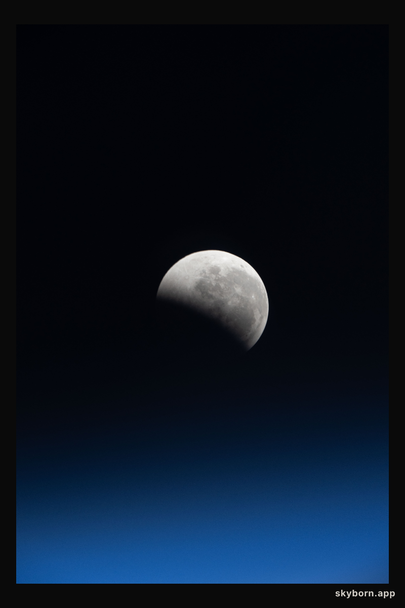 The lunar eclipse, also known as the Blood Moon, above Earth's horizon