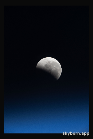 The lunar eclipse, also known as the Blood Moon, above Earth's horizon