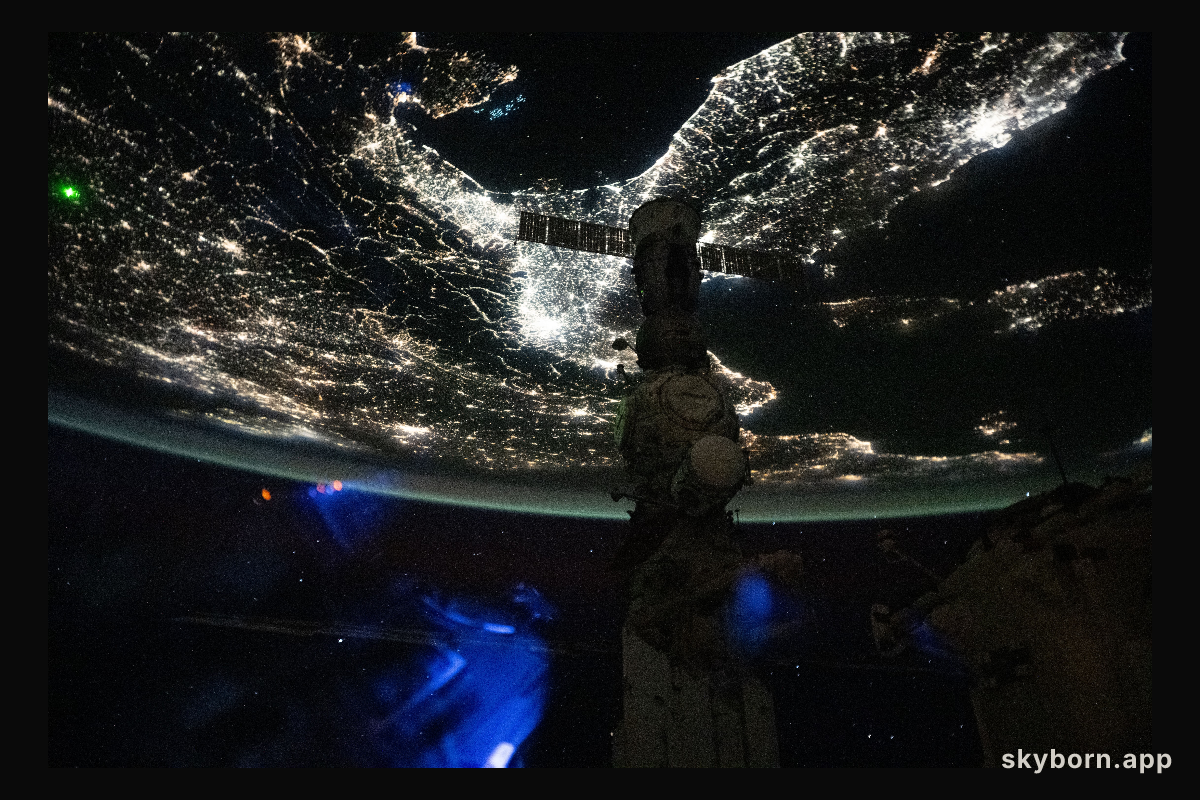 A faint blue-green airglow blankets Earth’s horizon above Italy