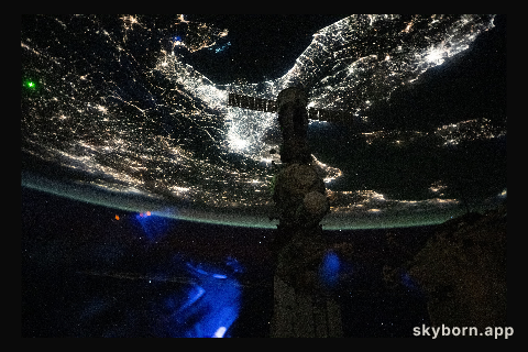 A faint blue-green airglow blankets Earth’s horizon above Italy