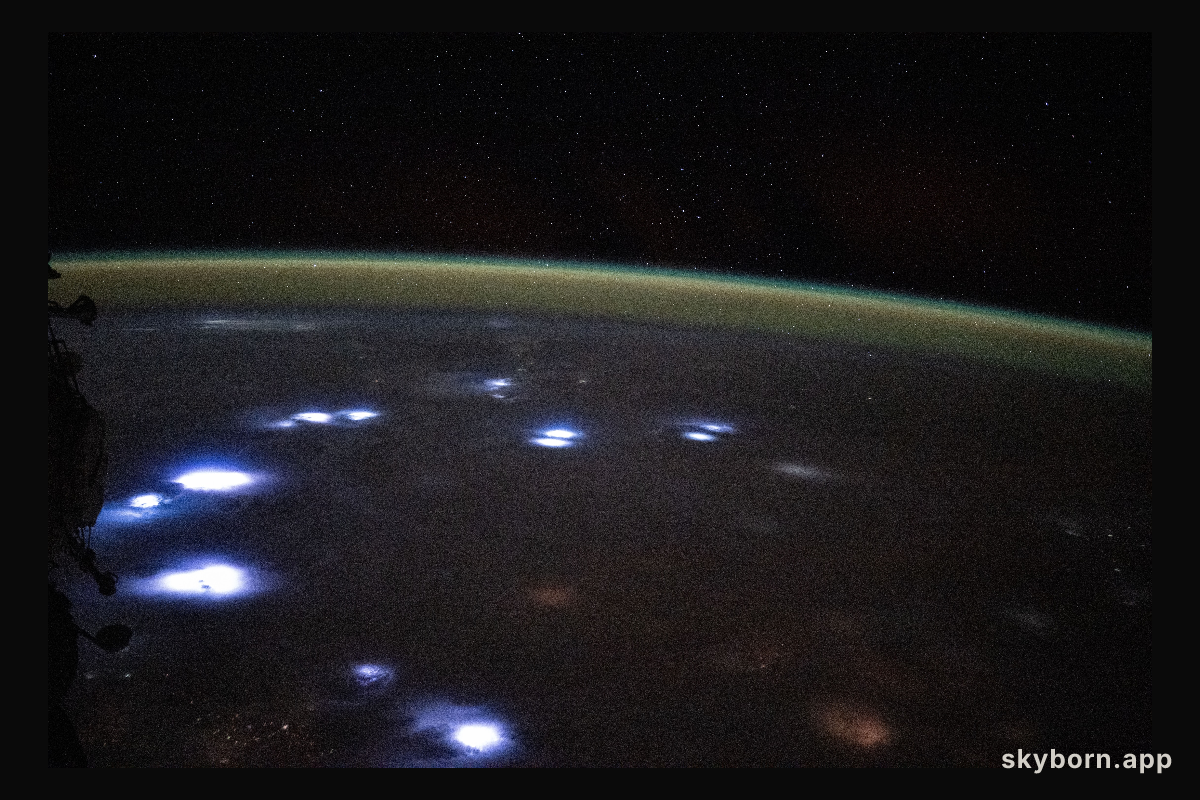 Bright lightning storms illuminate the cloudy landscape of western Africa
