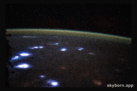 Bright lightning storms illuminate the cloudy landscape of western Africa