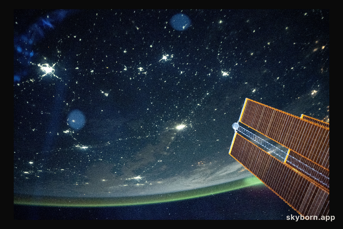 A tranquil, blue-green airglow blankets Earth's horizon above Kazakhstan