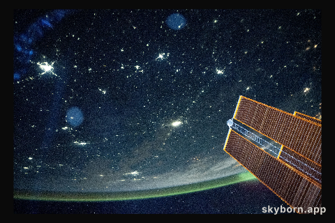 A tranquil, blue-green airglow blankets Earth's horizon above Kazakhstan
