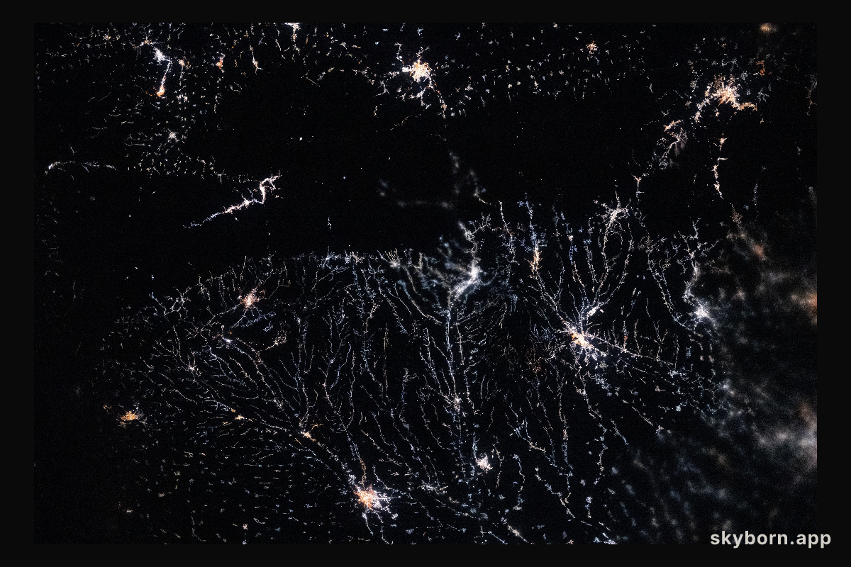City lights trace river valleys in the Wallachian Plain of Romania