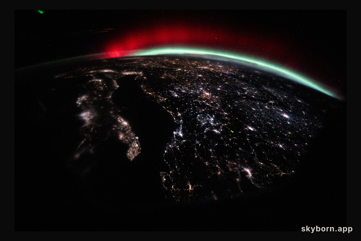 A green and red aurora streams across Earth’s horizon above Europe