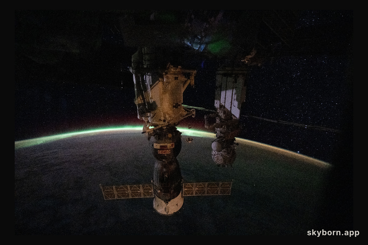 The aurora australis arcs above Earth’s horizon
