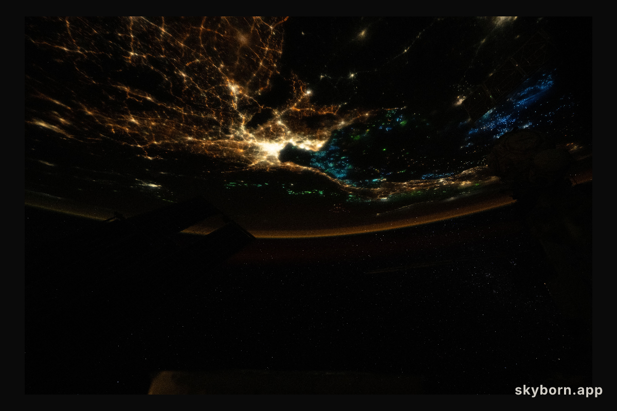 The blue lights of fishing boats dot the Gulf of Thailand contrasting with the city lights of Bangkok