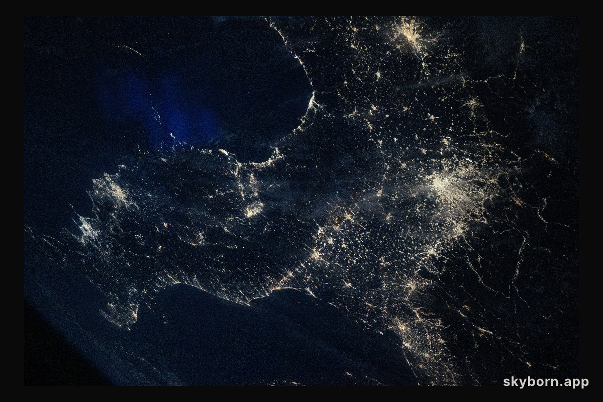 Italy’s darkened Po Valley contrasts with the brighter city lights that surround the region